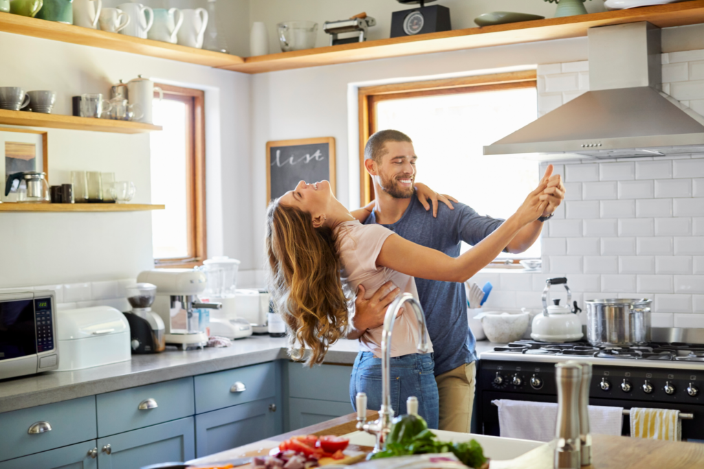 young couple dancing in their new kitchen

