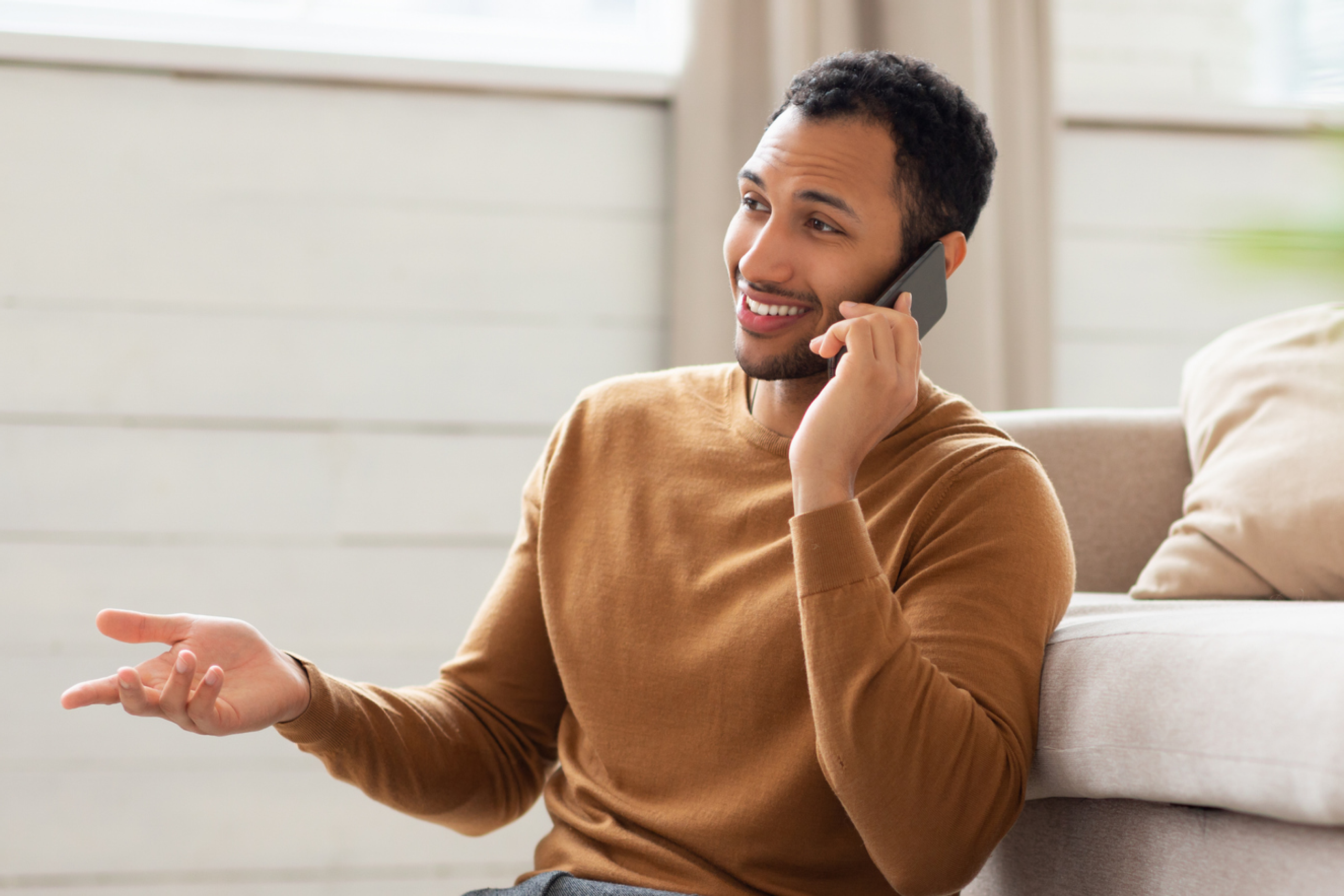 man talking on the phone in his living room