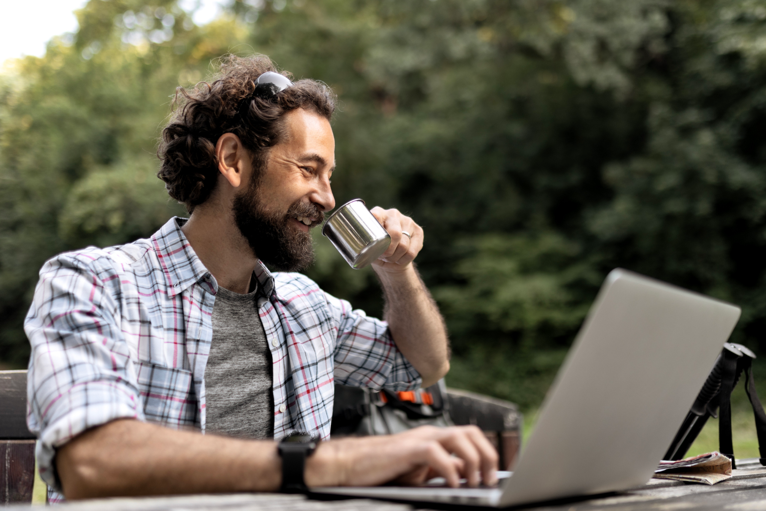 man working on laptop in the park 