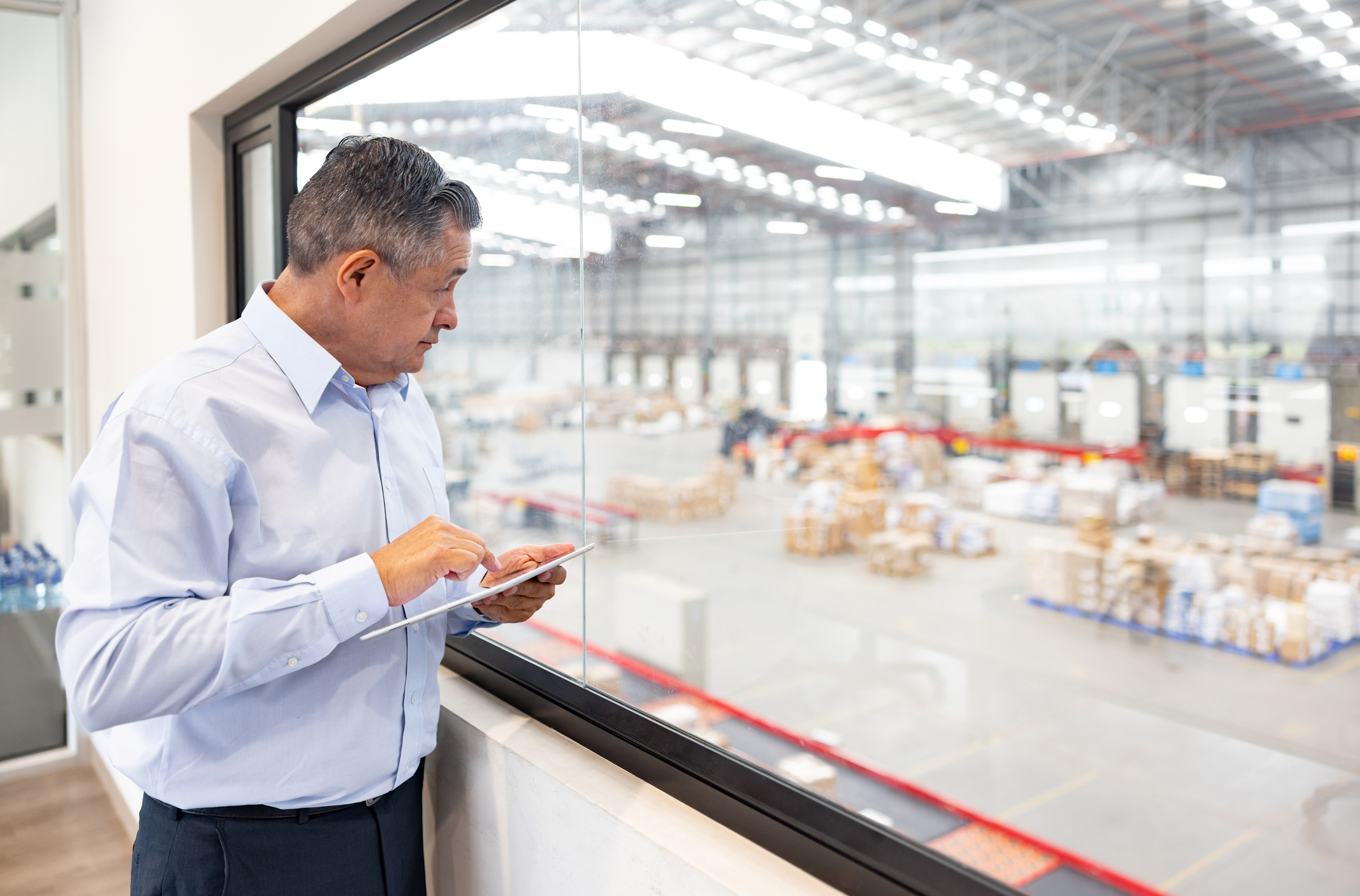 buisnessmen looking out over manufacture